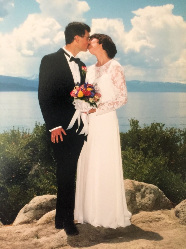 My husband & I kissing on our wedding day in front of Lake Tahoe