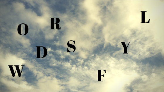 Words Fly - WORDS is jumbled. FLY is jumbled and on a diagonal rise. Background is wispy clouds.